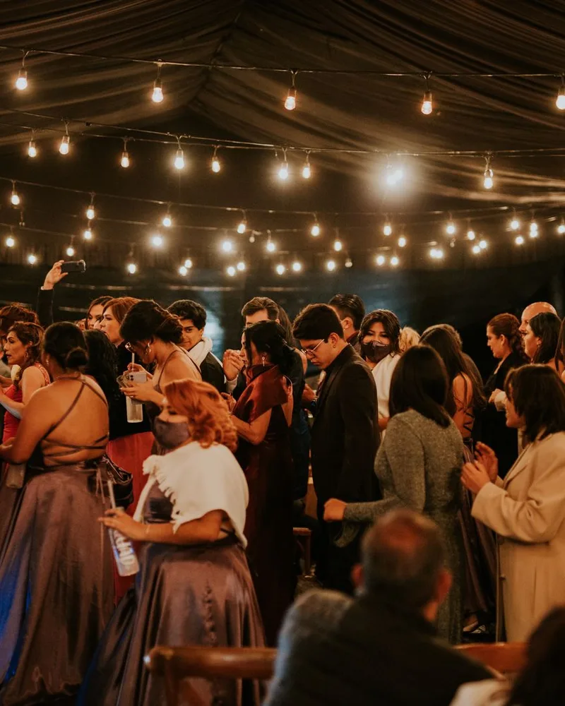 Guests dancing under string lights